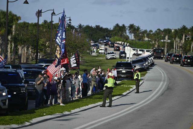 Supporters of US President Donald Trump cheer as he arrives in West Palm Beach, Florida on April 24, 2026. President Trump is heading to Palm Beach, Florida to attend the Republican National Committee (RNC) spring retreat. (Photo by Kent NISHIMURA / AFP)
