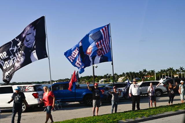 Supporters of US President Donald Trump cheer as he arrives in West Palm Beach, Florida on April 24, 2026. President Trump is heading to Palm Beach, Florida to attend the Republican National Committee (RNC) spring retreat. (Photo by Kent NISHIMURA / AFP)