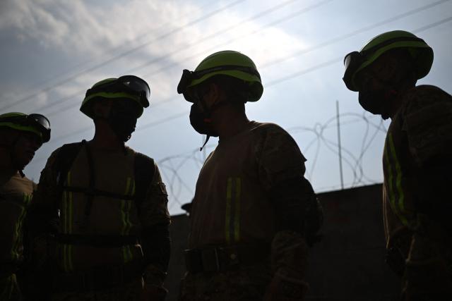 Salvadoran soldiers take part in a post-earthquake rescue simulation during the final phase of a 36 hour emergency exercise, held as part of the CENTAM Guardian 2026 military drills, at the Engineers Corps (CIFA) facilities in San Juan Opico, El Salvador on April 24, 2026. (Photo by Marvin RECINOS / AFP)