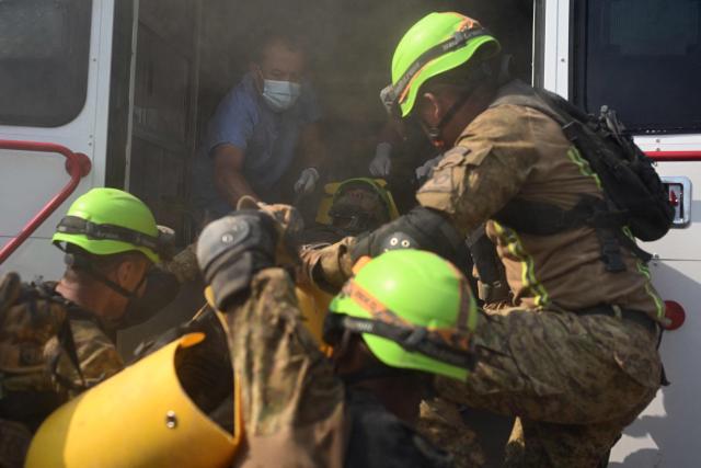 Salvadoran soldiers take part in a post-earthquake rescue simulation during the final phase of a 36 hour emergency exercise, held as part of the CENTAM Guardian 2026 military drills, at the Engineers Corps (CIFA) facilities in San Juan Opico, El Salvador on April 24, 2026. (Photo by Marvin RECINOS / AFP)