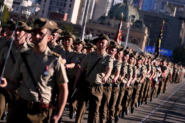 Soldiers march to the Shrine of Remembrance during a parade of former and current defence personnel on ANZAC (Australian and New Zealand Army Corps) Day to honour soldiers who have died in the line of duty, in Melbourne on April 25, 2026. (Photo by William WEST / AFP)
