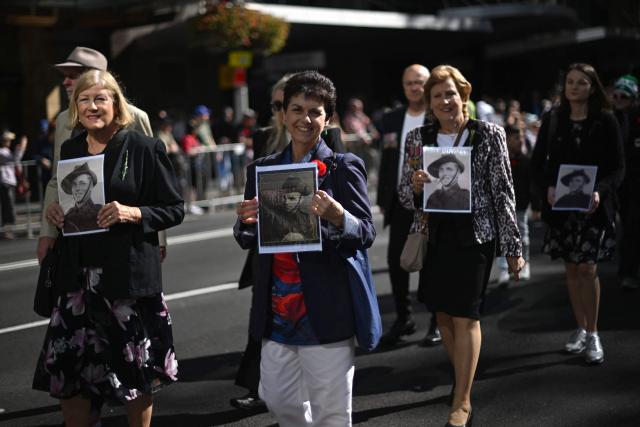 Participants carry photos of soldiers during the annual ANZAC (Australian and New Zealand Army Corps) Day parade in Sydney on April 25, 2026. Dawn services were held across the two countries on the anniversary of the ill-fated 1915 campaign of the Australian and New Zealand Army Corps that left 11,500 of them dead in what is now Turkey during World War I. (Photo by Saeed KHAN / AFP)