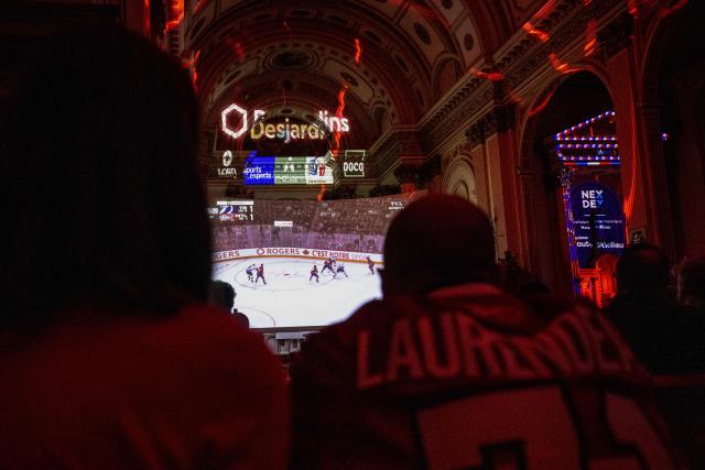 Montreal Canadiens fans watch the live broadcast of the Stanley Cup playoff game against Tampa Bay Lightning inside the Cathedrale Saint-Jean-l’Evangeliste, in Saint-Jean-sur-Richelieu, Quebec, on April 24, 2026. The cathedral, about 25 miles (40 kms) southeast of Montreal, is being transformed into a hockey "high mass" during the National Hockey League (NHL) playoffs. (Photo by ANDREJ IVANOV / AFP)