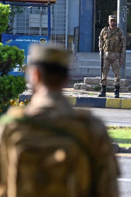 Army soldiers stand alert along a closed street at Red Zone area in Islamabad on April 25, 2026. Iran's foreign minister arrived in Islamabad on April 24 and US envoys headed to the Pakistani capital in a bid to kickstart a new round of peace negotiations amid a fragile ceasefire. (Photo by Aamir QURESHI / AFP)