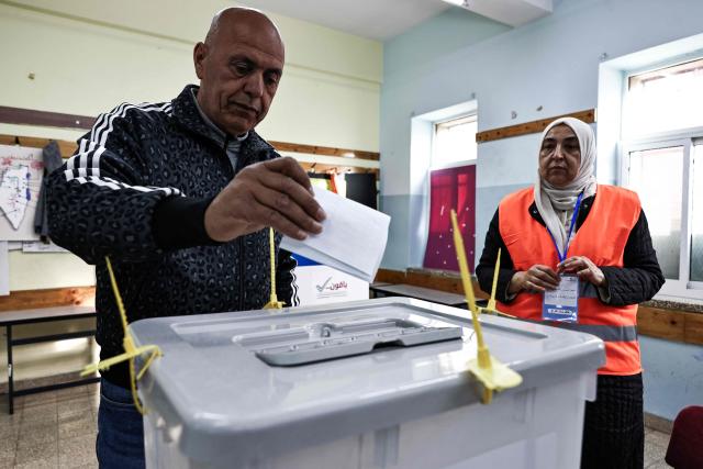 A Palestinian man casts his ballot at a polling station during municipal elections in the Israeli-occupied West Bank city of Al-Bireh on April 25, 2026. Palestinians in the West Bank and a central area of Gaza began voting on April 25 in municipal elections in a first vote since the Gaza war, marked by a narrow political field and widespread disillusionment. (Photo by Zain JAAFAR / AFP)