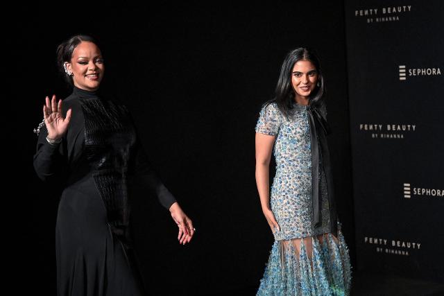 Barbadian singer and businesswoman Rihanna (L) and Isha Ambani, daughter of Chairman of Reliance Industries Mukesh Ambani, interact with media during an event of Rihanna's cosmetic brand 'Fenty Beauty' in Mumbai on April 25, 2026. (Photo by Sujit JAISWAL / AFP)