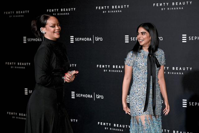 Barbadian singer and businesswoman Rihanna (L) and Isha Ambani, daughter of Chairman of Reliance Industries Mukesh Ambani, interact with media during an event of Rihanna's cosmetic brand 'Fenty Beauty' in Mumbai on April 25, 2026. (Photo by Sujit JAISWAL / AFP)