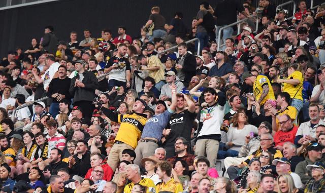 Fans cheer during round 11 Super Rugby Pacific match between the Hurricanes and Brumbies at One New Zealand Stadium in Christchurch on April 25, 2026. (Photo by Sanka Vidanagama / AFP)
