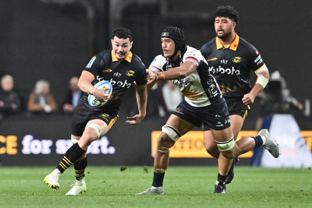 Hurricanes' Brayden Iose (L) runs with the ball during the Super Rugby Pacific match between the Hurricanes and Brumbies at One New Zealand Stadium in Christchurch on April 25, 2026. (Photo by Sanka VIDANAGAMA / AFP)