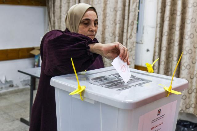 A Palestinian woman casts her ballot at a polling station during municipal elections in the village of al-Badhan, north of Nablus, in the Israeli-occupied West Bank on April 25, 2026. Palestinians in the West Bank and a central area of Gaza began voting on April 25 in municipal elections in a first vote since the Gaza war, marked by a narrow political field and widespread disillusionment. (Photo by JAAFAR ASHTIYEH / AFP)