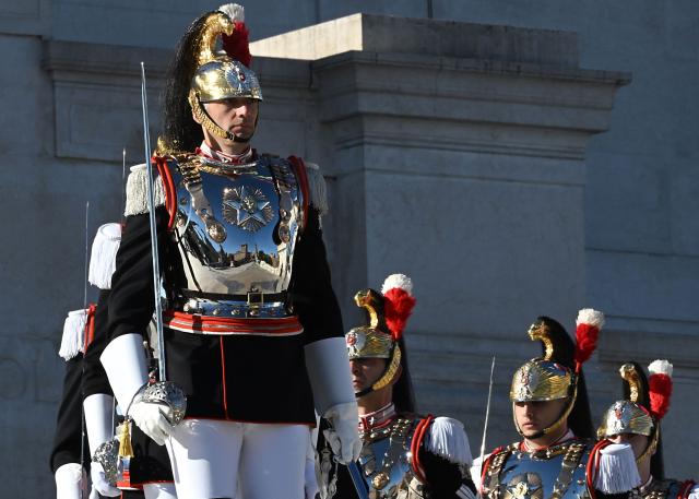 Corazzieri, or Italian military Presidential honour guards, take part in the wreath-laying ceremony at the Tomb of the Unknown Soldier of Victor Emmanuel II Monument for Italy's Liberation Day anniversary, in central Rome, on April 25, 2026. (Photo by Andreas SOLARO / AFP)