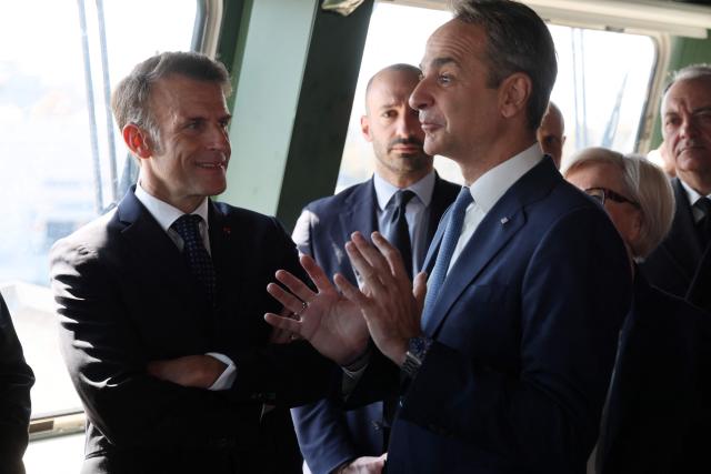 France's President Emmanuel Macron (L) and Greece's Prime Minister Kyriakos Mitsotakis visit Greece's new French-built frigate "Kimon" at the port of Piraeus near Athens, on April 25, 2026. (Photo by Ludovic MARIN / AFP)