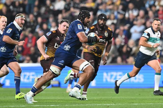 Blues' Patrick Tuipulotu (C) charges forward during the Super Rugby Pacific match between the Blues and Queensland Reds at One New Zealand Stadium in Christchurch on April 25, 2026. (Photo by Sanka VIDANAGAMA / AFP)