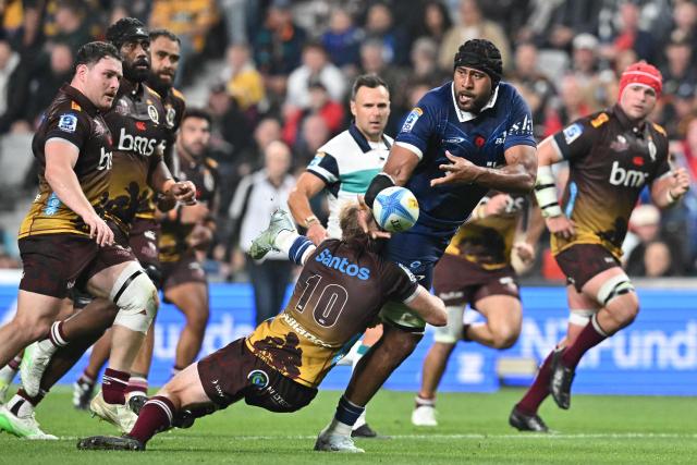 Blues' Patrick Tuipulotu (C) passes the ball during the Super Rugby Pacific match between the Blues and Queensland Reds at One New Zealand Stadium in Christchurch on April 25, 2026. (Photo by Sanka VIDANAGAMA / AFP)