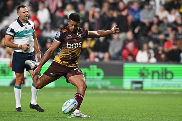 Reds' Ben Volavola kicks a goal during the Super Rugby Pacific match between the Blues and Queensland Reds at One New Zealand Stadium in Christchurch on April 25, 2026. (Photo by Sanka VIDANAGAMA / AFP)