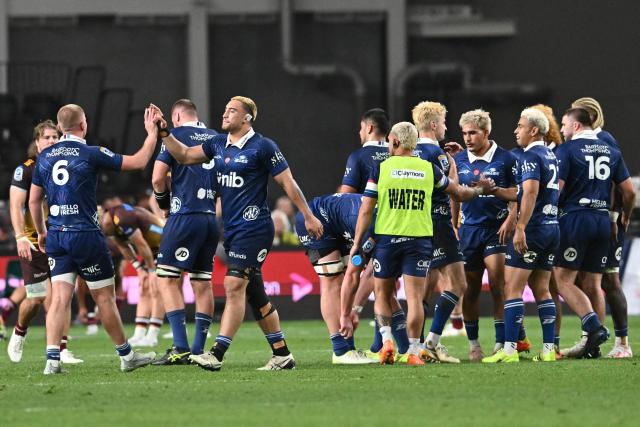 Blues' players celebrate their win during the Super Rugby Pacific match between the Blues and Queensland Reds at One New Zealand Stadium in Christchurch on April 25, 2026. (Photo by Sanka VIDANAGAMA / AFP)
