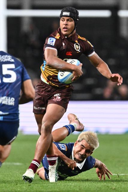 Reds' Treyvon Pritchard (L) is tackled by the Blues' defence during the Super Rugby Pacific match between the Blues and Queensland Reds at One New Zealand Stadium in Christchurch on April 25, 2026. (Photo by Sanka VIDANAGAMA / AFP)