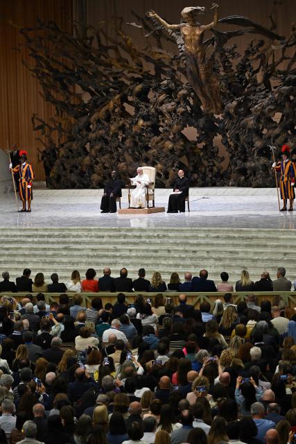 Pope Leo XIV (Rear C on stage) speaks during a private audience with participants in the National Meeting of Catholic Religion Teachers, who teach religion courses in Italian public schools, promoted by the CEI (Catholic Episcopal Conference), at Paul VI Hall in the Vatican on April 25, 2026. (Photo by Andreas SOLARO / AFP)