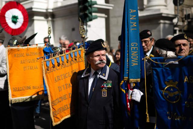 Members of veterans’ associations hold banners of their organizations during the march marking the 81st Liberation Day which commemorates the end of the Nazi-Fascist occupation in Italy during World War II in Genoa on April 25, 2026. (Photo by MARCO BERTORELLO / AFP)