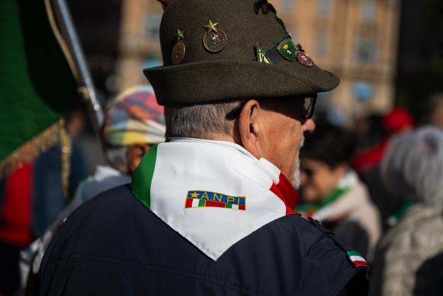 A man wears the scarf of Anpi (National Italian Partisan Association) during the march marking the 81st Liberation Day which commemorates the end of the Nazi-Fascist occupation in Italy during World War II in Genoa on April 25, 2026. (Photo by MARCO BERTORELLO / AFP)