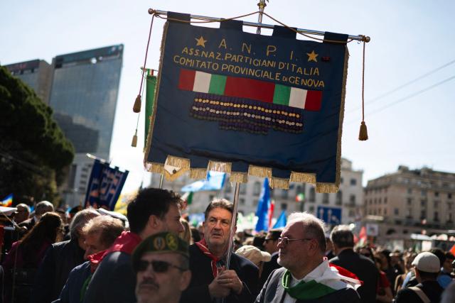 A man holds the banner of the Anpi (National Italian Partisan Association) during a march marking the 81st Liberation Day which commemorates the end of the Nazi-Fascist occupation in Italy during World War II in Genoa on April 25, 2026. A man holds the banner of the Associazione Nazionale Partigiani d’Italia, (National Italian Partisan Association) adorned with medals of valor during the march to mark the 81st Liberation Day, in Genoa on April 25, 2026. (Photo by MARCO BERTORELLO / AFP)