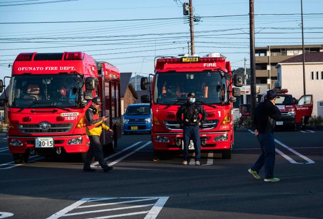Firefighters load up on supplies as they prepare to head into the mountains around the town of Otsuchi in Iwate Prefecture on April 25, 2026. Hundreds of firefighters were battling wildfires in the forests of northern Japan on April 25, as authorities urged more than 3,200 people to evacuate from their homes, government officials said. (Photo by ANDREW CABALLERO-REYNOLDS / AFP)