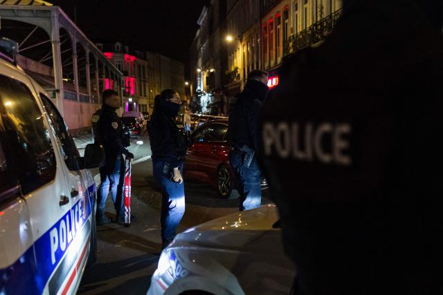French National Police officers stop a car during a roadside night check for nitrous oxide canisters in Lille, northern France, on April 25, 2026. (Photo by Sameer Al-DOUMY / AFP)