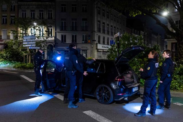 French National Police officers stop a car during a roadside night check for nitrous oxide canisters in Lille, northern France, on April 25, 2026. (Photo by Sameer Al-DOUMY / AFP)