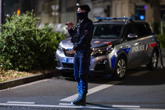 A French National Police officer stops a car during a roadside night check for nitrous oxide canisters in Lille, northern France, on April 25, 2026. (Photo by Sameer Al-DOUMY / AFP)