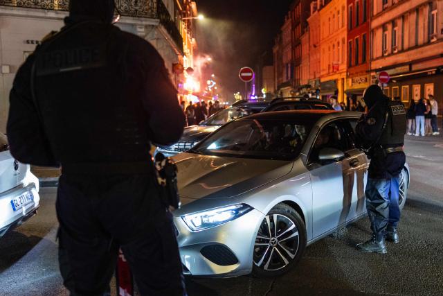 French National Police officers stop a car during a roadside night check for nitrous oxide canisters in Lille, northern France, on April 25, 2026. (Photo by Sameer Al-DOUMY / AFP)
