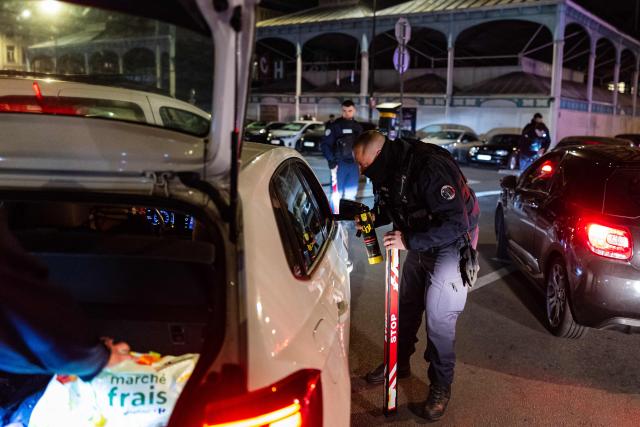 French National Police officer holds a nitrous oxide canister found inside a car during a roadside night check in Lille, northern France, on April 25, 2026. (Photo by Sameer Al-DOUMY / AFP)