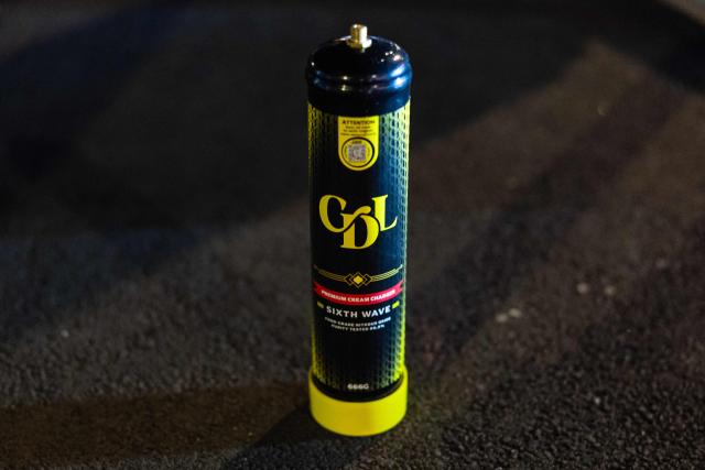 This photograph shows a nitrous oxide canister found inside a car by French National Police officers during a roadside night check in Lille, northern France, on April 25, 2026. (Photo by Sameer Al-DOUMY / AFP)