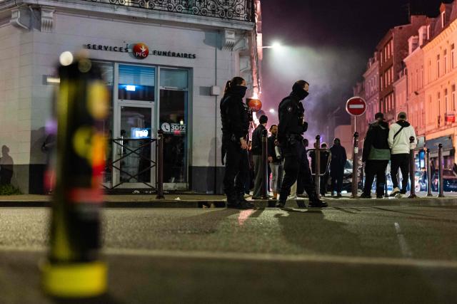 French National Police officers stand guard during a roadside night check for nitrous oxide canisters in Lille, northern France, on April 25, 2026. (Photo by Sameer Al-DOUMY / AFP)