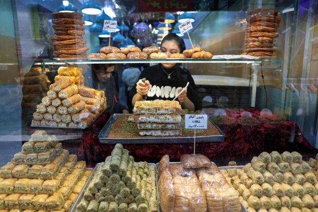 An Iranian woman works in a sweet shop, in Tehran on April 25, 2026. (Photo by AFP) / 