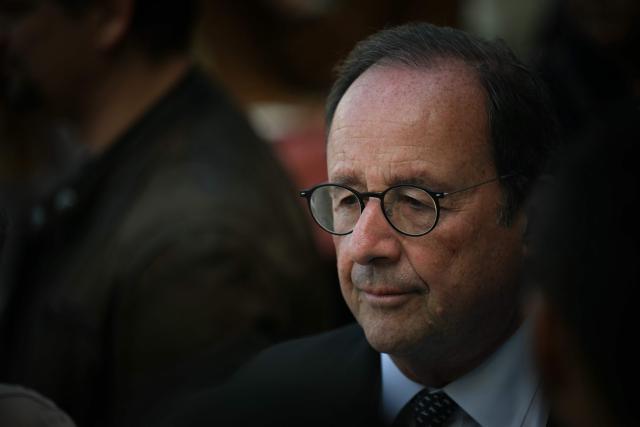 French former President and Socialistes et Apparentes' MP Francois Hollande (C) looks on as he attends a meeting of various figures of the left named "Printemps du souffle breton" in Liffre, western France on April 25, 2026. (Photo by LOU BENOIST / AFP)
