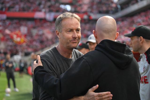 Bayer Leverkusen's Danish head coach Kasper Hjulmand (L) greets FC Cologne's Czech head coach Rene Wagner prior to the German first division Bundesliga football match 1 FC Cologne v Bayer 04 Leverkusen in Cologne, western Germany, on April 25, 2026. (Photo by INA FASSBENDER / AFP) / DFL REGULATIONS PROHIBIT ANY USE OF PHOTOGRAPHS AS IMAGE SEQUENCES AND/OR QUASI-VIDEO