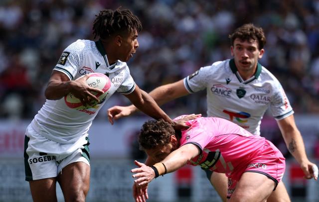 CORRECTION / Theo Pau's French wing Thйo Attissogbe (L) runs with a ball during the French Top 14 rugby union match between Stade Francais and  Section Paloise (Pau) at the Jean Bouin stadium in Paris, on April 25, 2026. (Photo by FRANCK FIFE / AFP) / “The erroneous mention[s] appearing in the metadata of this photo by FRANCK FIFE has been modified in AFP systems in the following manner: [Theo Attissogbe] instead of [Aaron Grandidier-Nkanang]. Please immediately remove the erroneous mention[s] from all your online services and delete it (them) from your servers. If you have been authorized by AFP to distribute it (them) to third parties, please ensure that the same actions are carried out by them. Failure to promptly comply with these instructions will entail liability on your part for any continued or post notification usage. Therefore we thank you very much for all your attention and prompt action. We are sorry for the inconvenience this notification may cause and remain at your disposal for any further information you may require.”