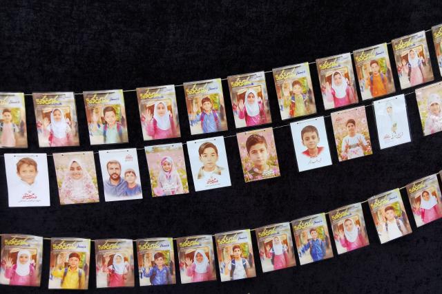 Images of children killed on the first day of the war in an alleged US-Israeli missile strike on a school in the southern Iranian city of Minab are strung along the wall of a mosque in the capital Tehran on April 25, 2026. On February 28, Israel and the United States launched strikes on Iran, killing its supreme leader and triggering a war that spread across the Middle East. (Photo by ATTA KENARE / AFP) / 