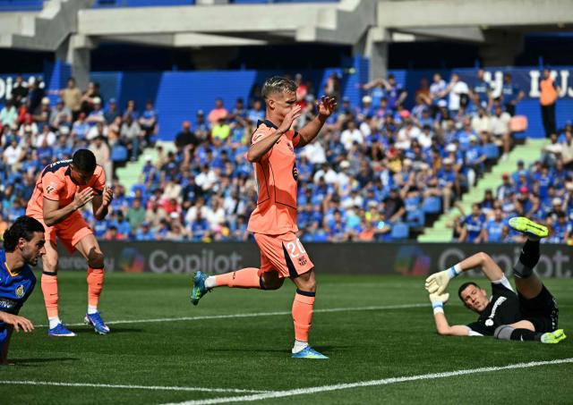 Barcelona's Spanish midfielder #20 Daniel Olmo (C) reacts after missing a goal opportunity during the Spanish league football match between Getafe CF and FC Barcelona at the Coliseum stadium in Getafe on April 25 , 2026. (Photo by Javier SORIANO / AFP)