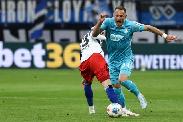 Hamburg's Danish midfielder #23 Albert Gronbaek (L) and Hoffenheim's Czech midfielder #34 Vladimir Coufal vie for the ball during the German first division Bundesliga football match between Hamburger SV and TSG 1899 Hoffenheim in Hamburg, northern Germany on April 25, 2026. (Photo by Ibrahim OT / AFP) / DFL REGULATIONS PROHIBIT ANY USE OF PHOTOGRAPHS AS IMAGE SEQUENCES AND/OR QUASI-VIDEO