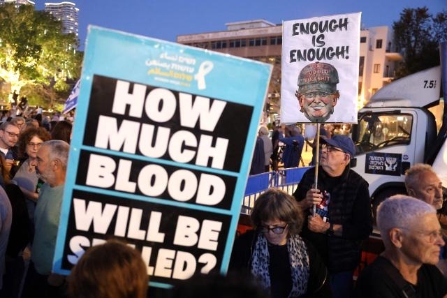 Israeli left-wing activists holding up placards demonstrate in HaBima Square against the ongoing war with Iran and against the Israeli government, in Tel Aviv on April 25, 2026. Since the ceasefire between Israel, the United States, and Iran came into effect, a relative calm has prevailed, with no bombings reported in Iran or the Gulf, after five weeks of conflict that left thousands dead, primarily in Iran and Lebanon. (Photo by Jack GUEZ / AFP) / 