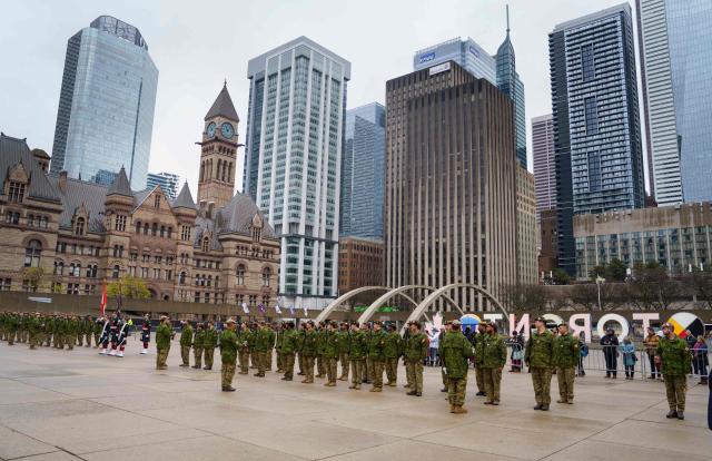 The 48th Highlanders of Canada stand in formation at City Hall during their Freedom of the City parade and ceremony in Toronto, on April 25, 2026. The 48th Highlanders of Canada is an active Canadian Forces Primary Reserve infantry regiment formed in 1891 that fought in both World Wars. Freedom of the City is a prestigious honour granted to military units with long-standing ties to a municipality. Rooted in a 15th-century English tradition, the ceremony remains significant in the Canadian Army today. This year also marks the 135th anniversary of the 48th Highlanders. (Photo by Peter POWER / AFP)