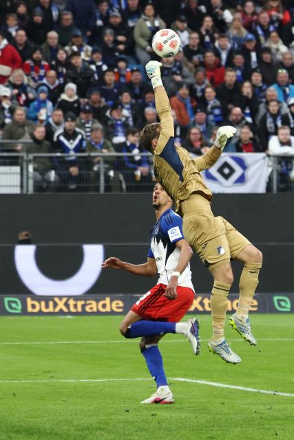 Hamburg's German forward #09 Robert Glatzel (L) reacts as Hoffenheim's German goalkeeper #01 Oliver Baumann fails to save the ball during the German first division Bundesliga football match between Hamburger SV and TSG 1899 Hoffenheim in Hamburg, northern Germany on April 25, 2026. (Photo by Ibrahim OT / AFP) / DFL REGULATIONS PROHIBIT ANY USE OF PHOTOGRAPHS AS IMAGE SEQUENCES AND/OR QUASI-VIDEO