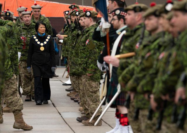 Mayor of Toronto Olivia Chow is escorted by Commanding Officer Lt. Col. Tyler Wentzell, as she inspects the troops of the 48th Highlanders of Canada during their Freedom of the City parade and ceremony in Toronto, on April 25, 2026. The 48th Highlanders of Canada is an active Canadian Forces Primary Reserve infantry regiment formed in 1891 that fought in both World Wars. Freedom of the City is a prestigious honour granted to military units with long-standing ties to a municipality. Rooted in a 15th-century English tradition, the ceremony remains significant in the Canadian Army today. This year also marks the 135th anniversary of the 48th Highlanders. (Photo by Peter POWER / AFP)