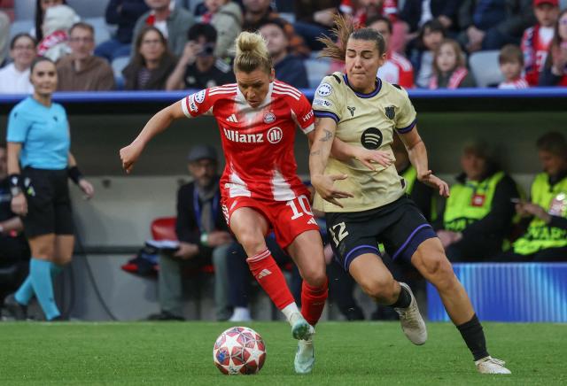 Bayern Munich's German midfielder #10 Linda Dallmann and Barcelona's Spanish midfielder #12 Patricia Guijarro vie for the ball during the UEFA Women's Champions League semi-final first leg football match between FC Bayern Munich and FC Barcelona in Munich, southern Germany on April 25, 2026. (Photo by Karl-Josef HILDENBRAND / AFP)