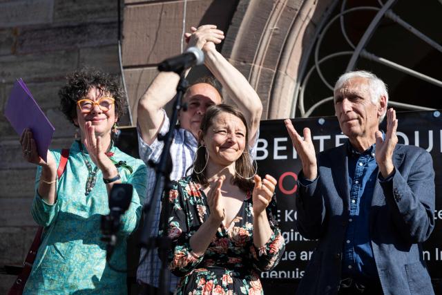 (From L) Cecile Kohler's mother Mireille Kohler, Cecile Kohler's father Pascal Kohler and French nationals Cecile Kohler and Jacques Paris applaud during a ceremony to symbolically take down a banner displayed on the town hall in their hometown of Soultz-Haut-Rhin, eastern France on April 25, 2026. Cecile Kohler, 41, and Jacques Paris, 72, arrested on espionage charges and imprisoned for almost four years in Iran, returned home on April 8, 2026. (Photo by ROMEO BOETZLE / AFP)