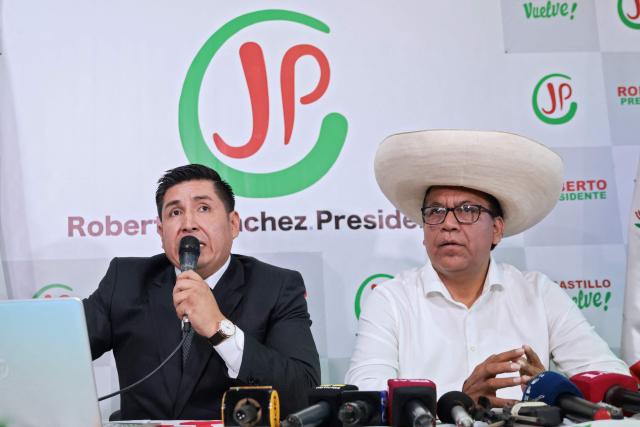 Peruvian presidential candidate for the Juntos por el Peru party, Roberto Sanchez (R) and his lawyer Roy Mendoza Navarro, speak during a press conference at the party's headquarters in Lima on April 25, 2026. (Photo by Connie FRANCE / AFP)