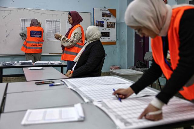 Palestinian electoral employees begin counting votes for the municipal elections after the close of polling stations in the Israeli-occupied West Bank city of Al-Bireh on April 25, 2026. Palestinians in the West Bank and a central area of Gaza began voting on April 25 in municipal elections in a first vote since the Gaza war, marked by a narrow political field and widespread disillusionment. (Photo by Zain JAAFAR / AFP)