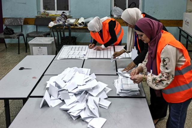 Palestinian electoral employees begin counting votes for the municipal elections after the close of polling stations in the Israeli-occupied West Bank city of Al-Bireh on April 25, 2026. Palestinians in the West Bank and a central area of Gaza began voting on April 25 in municipal elections in a first vote since the Gaza war, marked by a narrow political field and widespread disillusionment. (Photo by Zain JAAFAR / AFP)