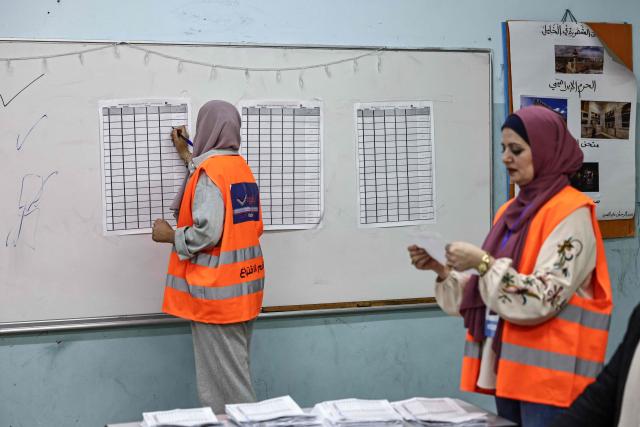 Palestinian electoral employees begin counting votes for the municipal elections after the close of polling stations in the Israeli-occupied West Bank city of Al-Bireh on April 25, 2026. Palestinians in the West Bank and a central area of Gaza began voting on April 25 in municipal elections in a first vote since the Gaza war, marked by a narrow political field and widespread disillusionment. (Photo by Zain JAAFAR / AFP)